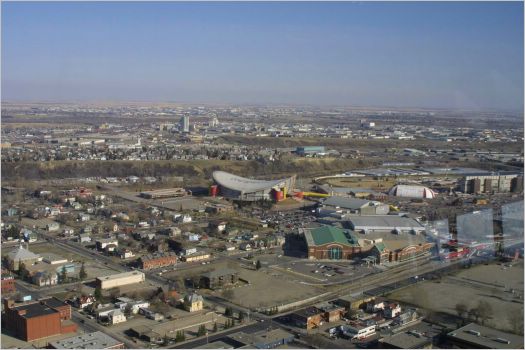 View from 190.8 metre high Calgary Tower, Calgary city,  Alberta, Canada,  1,228.2 metres above sea level. The odd shaped roof building is the football stadium.