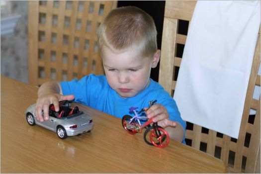 Kyle happily playing cars