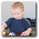 Gavin happily playing cars
