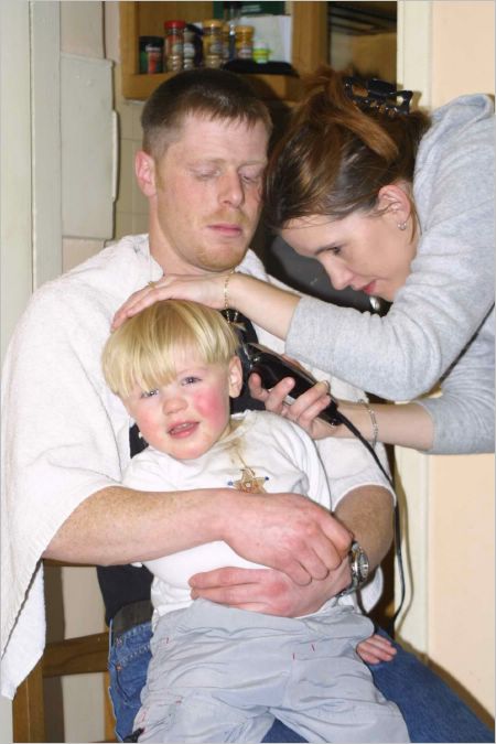 Time for a haircut. Kyle was not pleased and cried through the whole proceedings, calmy ignored by his parents