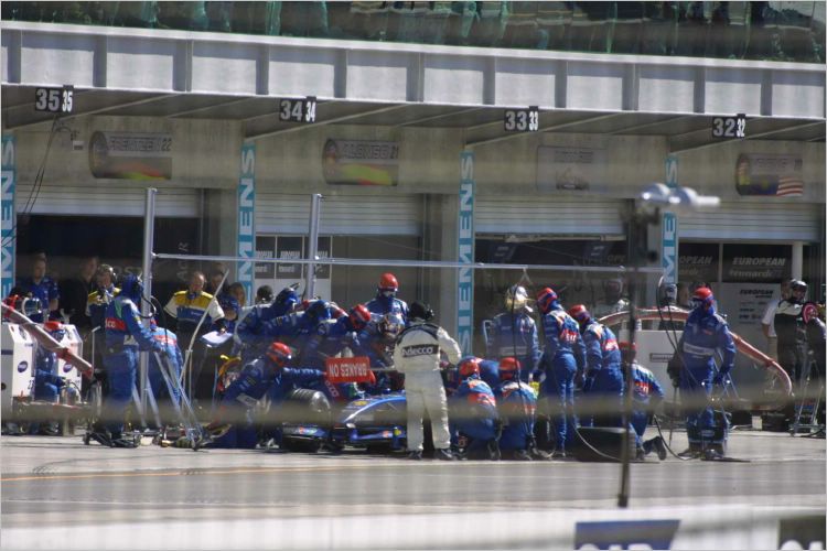 Pit crew working on Heinz Harold Frentzen's car.