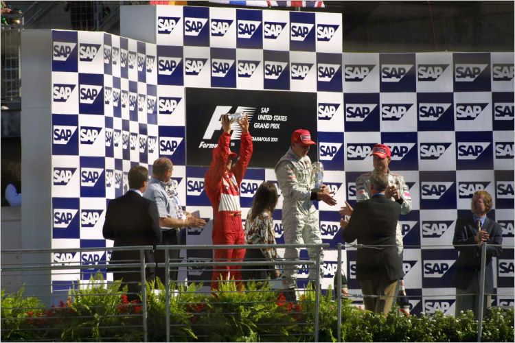 Michael Schumacher proudly holds up his trophy