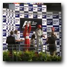Michael Schumacher proudly holds up his trophy