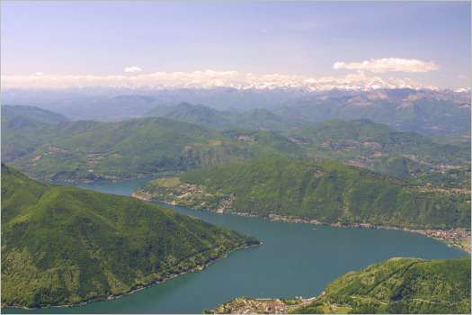 Lake Lugano taken from the summit of Monte Generoso. See the snow-covered Alps in the distance.