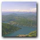 Lake Lugano taken from the summit of Monte Generoso. See the snow-covered Alps in the distance.