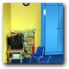 Matching blue chairs watched over by Bob the Builder clock that tells the boys how long they can play their computer games