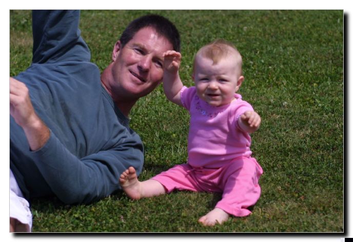 Rylie's first time to sit on grass and she wasn't too sure about it. Get me outta here Dad!